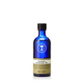 A 100ml bottle of brown-labeled blue Neal's Yard Remedies Aromatic Massage Oil against a white background. 