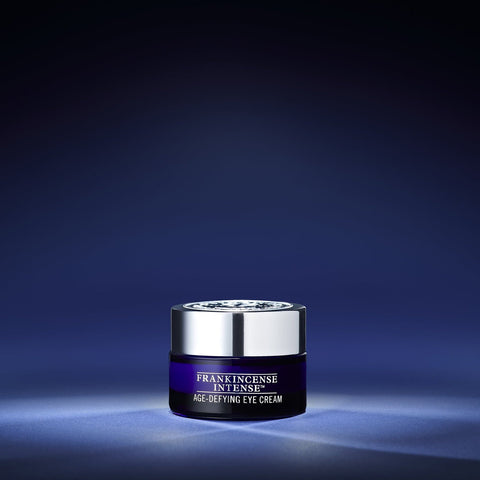 Neal's Yard Remedies Frankincense Intense Age-Defying Eye Cream 15 glamour shot on ablue background with highlight in the middle. 