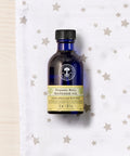 Neal's Yard Remedies Organic Baby Massage Oil Front Product Photo Shot with nice background filled with stars printed cloth