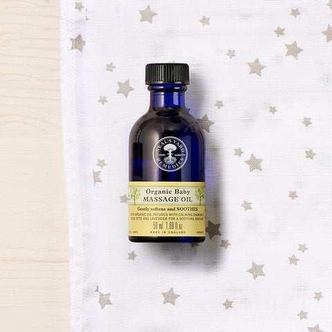 Neal's Yard Remedies Organic Baby Massage Oil Front Product Photo Shot with nice background filled with stars printed cloth