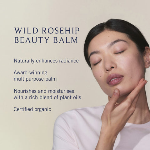 Woman applying Wild Rosehip Beauty Balm with product description text on a beige background