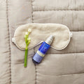 Beauty Sleep Concentrate spray bottle on bedspread background