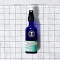 Lavender & Aloe Vera Deodorant spray bottle on plaid background