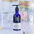 Rose Facial Wash bottle with spa and flower background